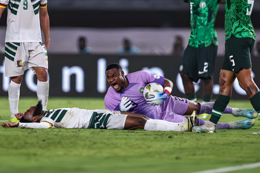 Stanley Nwabali groans in pain after getting hurt in the game against Cameroon. Photo: AFP